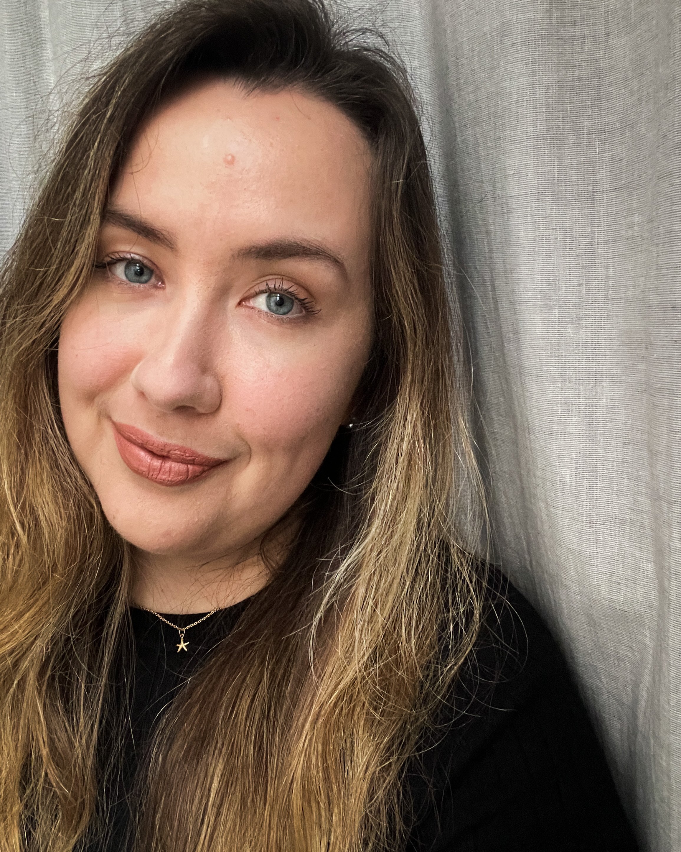 Selfie of Han against grey curtain background